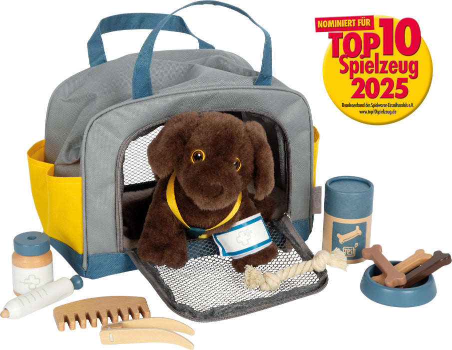 Hund mit Tasche und Pflege-Set