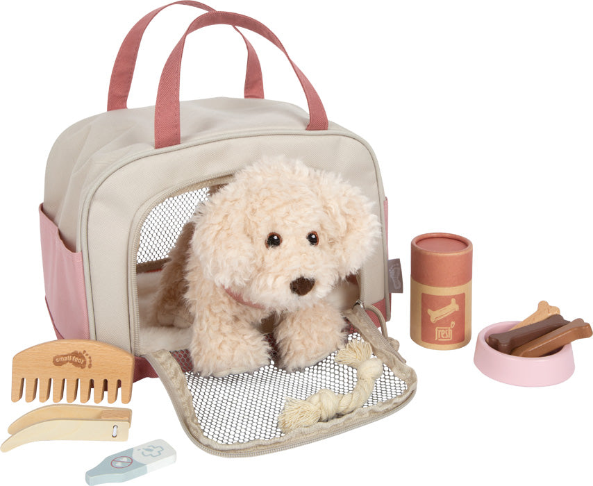 Hund mit rosa Tasche und Pflege-Set